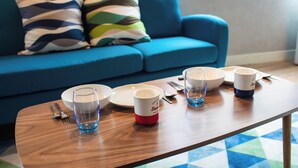 A dining table with a blue and white mug, a glass, and a plate. - Chateau Yoyogi 1-401 (Tokyo)