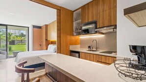 A modern kitchen with wooden cabinets, a built-in microwave, and a large island with a sink.