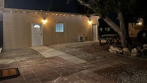 A building with two doors, a bench, and a tree. - Cozy Private Studio (Quartz Hill)