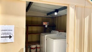 A laundry room with a sign directing to use the other sliding door. - Cozy Private Studio (Quartz Hill)