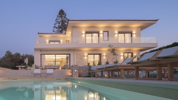 A modern two-story house with a swimming pool, outdoor seating, and a stone facade. - Costa Villa , Walk to Sandy Beach & Heated Pool (88XM+XWC Pirgos)
