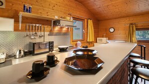 A kitchen with a microwave, kettle, and coffee maker. - 'Holzhaus Grimm' with private terrace and Wi-Fi (Fedderingen)