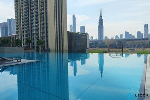 En swimmingpool med en stadsbild i bakgrunden, inklusive Burj Khalifa.