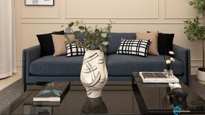 A living room with a blue sofa, a white vase with green plants, a coffee table, and a framed picture on the wall. - Prime Spacious 2 BR Apt, Burj Khalifa & Canal View (Dubai)