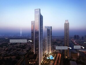 A high-rise building with "EMAAR" branding, surrounded by urban infrastructure including Dubai Mall Zabeel and a walkover bridge.