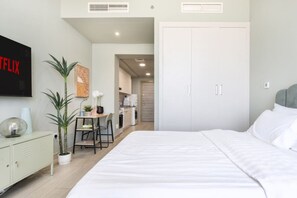1 bedroom, desk, iron/ironing board, travel crib