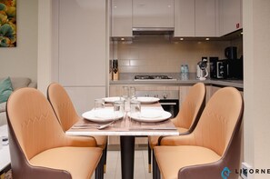 A modern kitchen with a dining area.