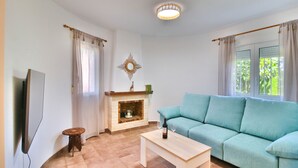 A living room with a fireplace, a sofa, a coffee table, and a TV. - All inclusive villa in Denia with pool 4p (Denia)