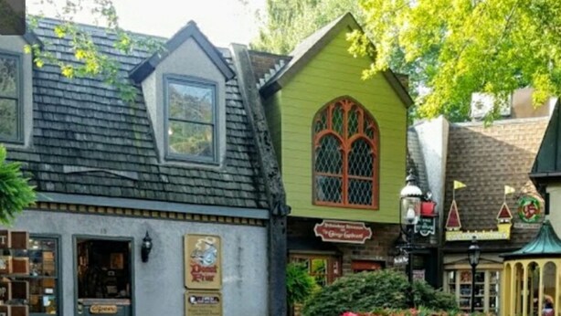 A quaint building with a green facade, a window with a decorative design, and a sign that reads "The George." - Modern Style 2 Bed Condo Pool in Gatlinburg (Gatlinburg)
