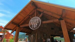 A wooden structure with a sign reading "CLIFF TOP Grill & Bar". - Modern Style 2 Bed Condo Pool in Gatlinburg (Gatlinburg)