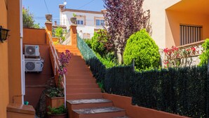 A stone staircase leading up to a building with a beige exterior.