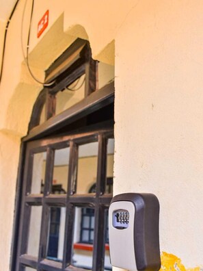 A keypad lock on a wall near a window. - Lux Suites RFH Apartments Ruiru (Ruiru)