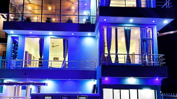 A multi-story building with balconies, large windows, and a modern design.