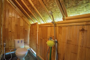 A wooden bathroom with a toilet, shower, and bamboo ceiling. - Lembah Wanna (Banjarangkan)