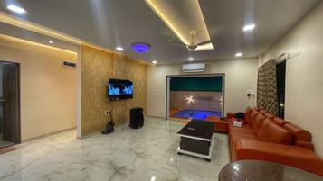 Villa, Pool View | Living area | Flat-screen TV