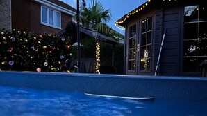 A swimming pool with a dark sky in the background.