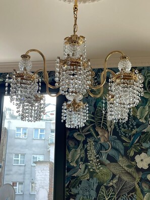A chandelier with multiple crystal elements and gold accents.