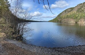 A calm lake surrounded by forested hills. - 3 Mackay Road Dornoch (Dornoch)