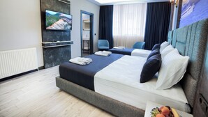 A modern hotel room with a large bed, two bedside tables, a flat-screen TV, a desk, and a chair. - Comfort Point Two Hotel  (Istanbul)