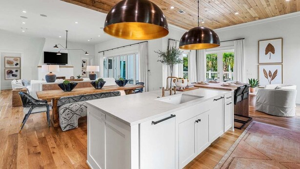 A modern kitchen with a large island, pendant lights, and a wooden ceiling. - Sleeps 18! Private Pool, Spa, LSV/Golf Cart! Gulf Views from Rooftop! Pet Friendly! (Santa Rosa Beach)
