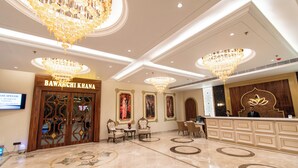 A luxurious hotel lobby with chandeliers, a reception desk, and ornate wall decorations. - Hotel Miracle Resorts (Phagwara)