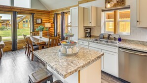 A modern kitchen with granite countertops, stainless steel appliances, and a breakfast bar.