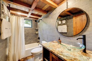 A bathroom with a glass sink, white toilet, and bathtub. - Dreamy Penrose Cabin w/ Panoramic Mountain Views (Penrose)