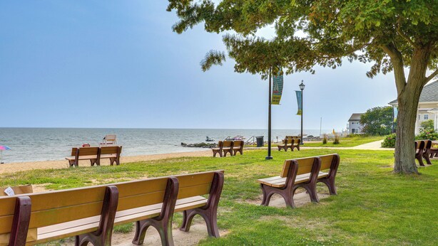 A park with benches along a path by the water. - Walk to Beaches: Sunny East Haven Home w/ Grill (East Haven)