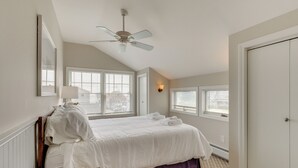 A bedroom with a bed, a ceiling fan, and a window. - Walk to Beaches: Sunny East Haven Home w/ Grill (East Haven)