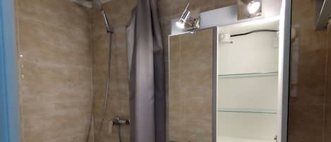 Shower, hair dryer, towels, toilet paper