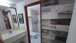 A bathroom with a white sink, mirror, and tiled floor. - Hotel Estrella Matamoros (Matamoros)