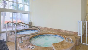 A hot tub with a metal railing and a sign indicating a 3-foot depth. - Phoenix Gulf Shores 803 3 Bedroom Condo by RedAwning (Gulf Shores)