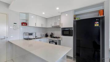 Coffee/tea maker, fridge, microwave, oven