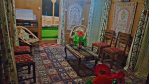 A room with patterned carpet, wooden furniture, and decorative rugs. - N Mumbai Group Of House Boat (Srinagar)