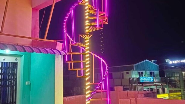 A building with a staircase illuminated by neon lights. - Raj Kamal Lodge (Chirala)