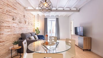 Superior Apartment, City View | Living area | 50-inch Smart TV with digital channels