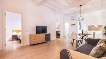 Superior Apartment, City View | Living area | 50-inch Smart TV with digital channels