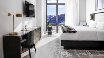 Une chambre moderne avec un grand lit, un bureau et un téléviseur.
