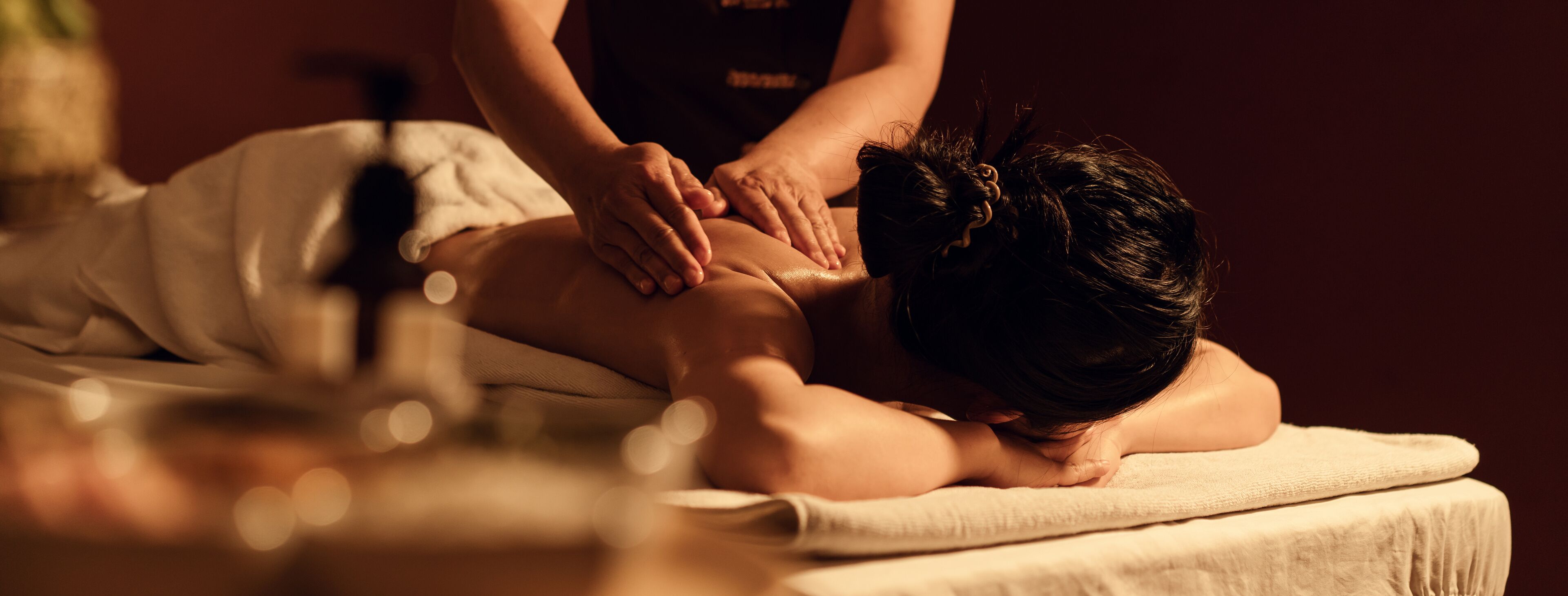 A person receiving a massage on a massage table.