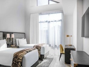 A modern hotel room with two beds, a desk, a chair, and a large window with sheer curtains. - Residences At Grand Hyatt Deer Valley (Park City)