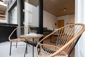 Relax in a stylish space with a casual dining area, featuring two chairs and a small table.
