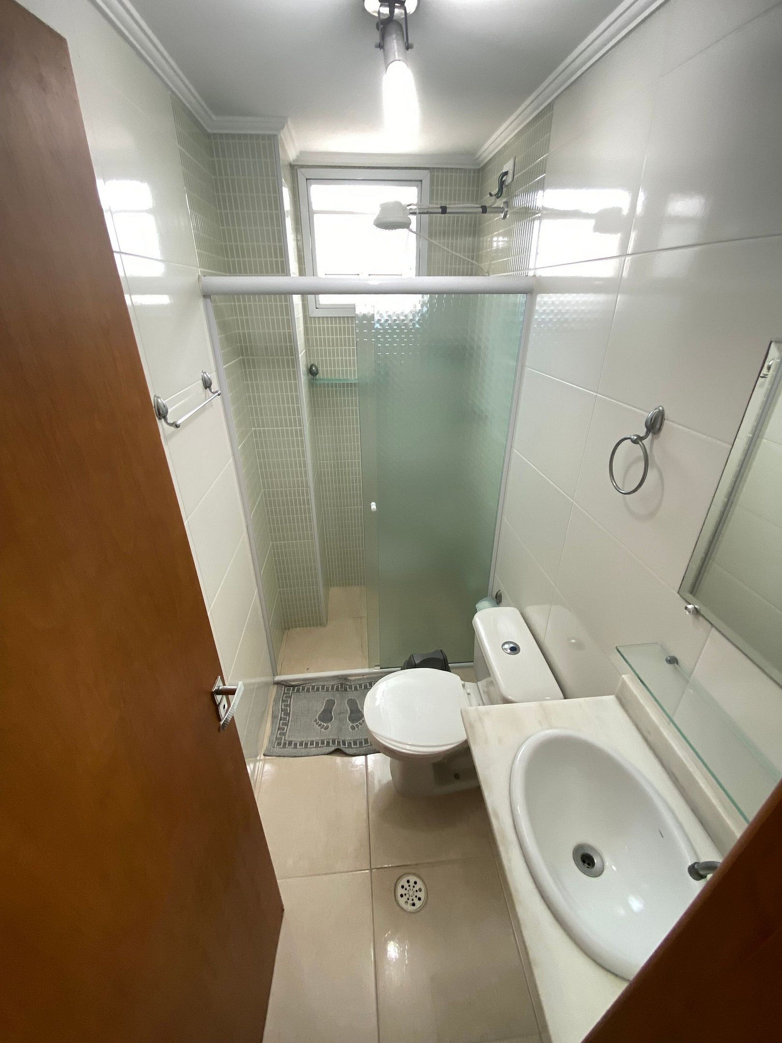 A small bathroom with a toilet, bidet, and sink.