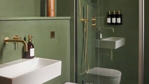 A modern bathroom with a white sink, a toilet, and a glass-enclosed shower area. - Yarn - Elmo Luxury Double Suite (Ballycastle)