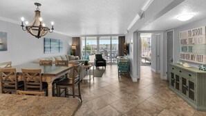 A spacious kitchen with a dining area, large windows, and a view of the outdoors.