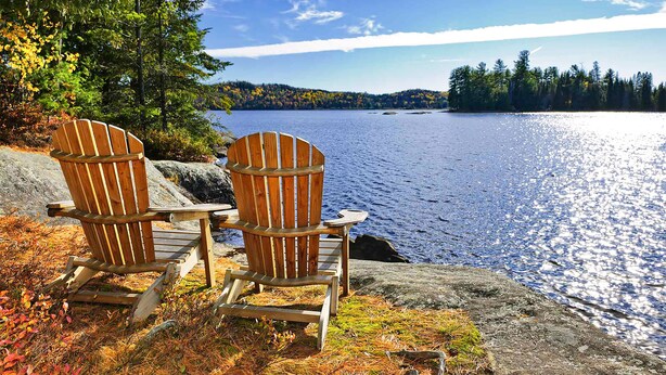 Two Adirondack chairs by a lake with a forested shoreline. - Fall Sale! Luxury Cabin. Top Location. Hot Tub Game Room EV Firepit (Blue Ridge)