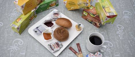A breakfast setup with various food items and coffee products on a table.