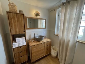 A bathroom with a wooden vanity, a large mirror, a bowl sink, and a window with a curtain. - Le Murier:  in the heart of a farmhouse (Mittelhausbergen)