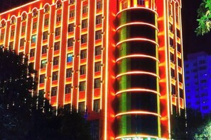 A multi-story building with a series of balconies and windows.