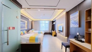 A hotel room with two beds, a desk, a chair, a TV, and a painting on the wall. - Jiangsu Hotel (Yining City)