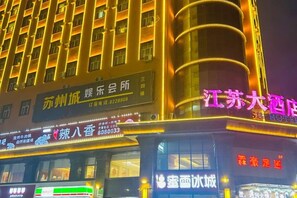 A hotel with multiple signs indicating various services and amenities.